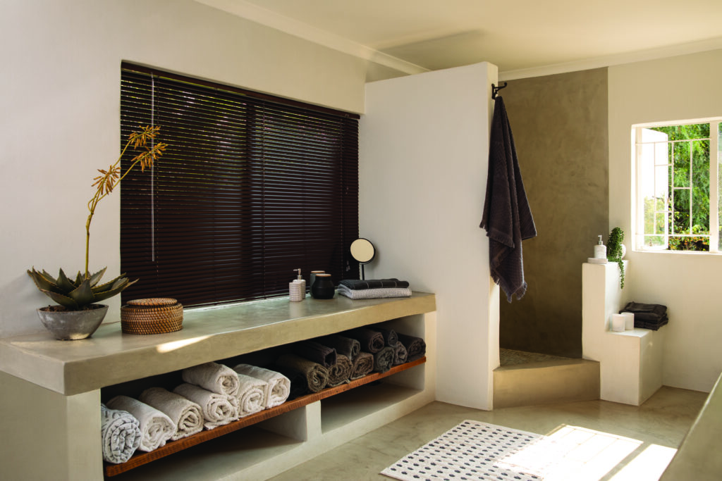 A boho style bathroom with aluminum venetia blinds